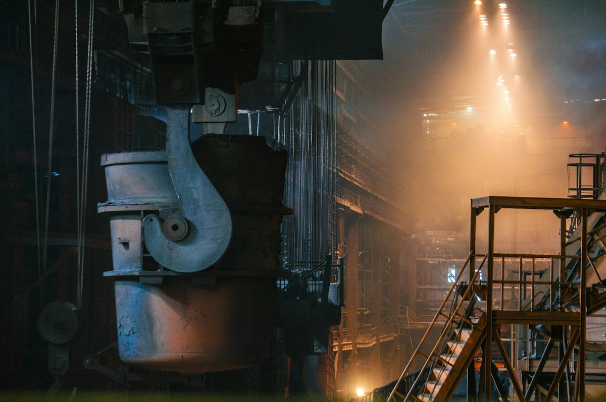 Steelworks hall with a large ladle against the light